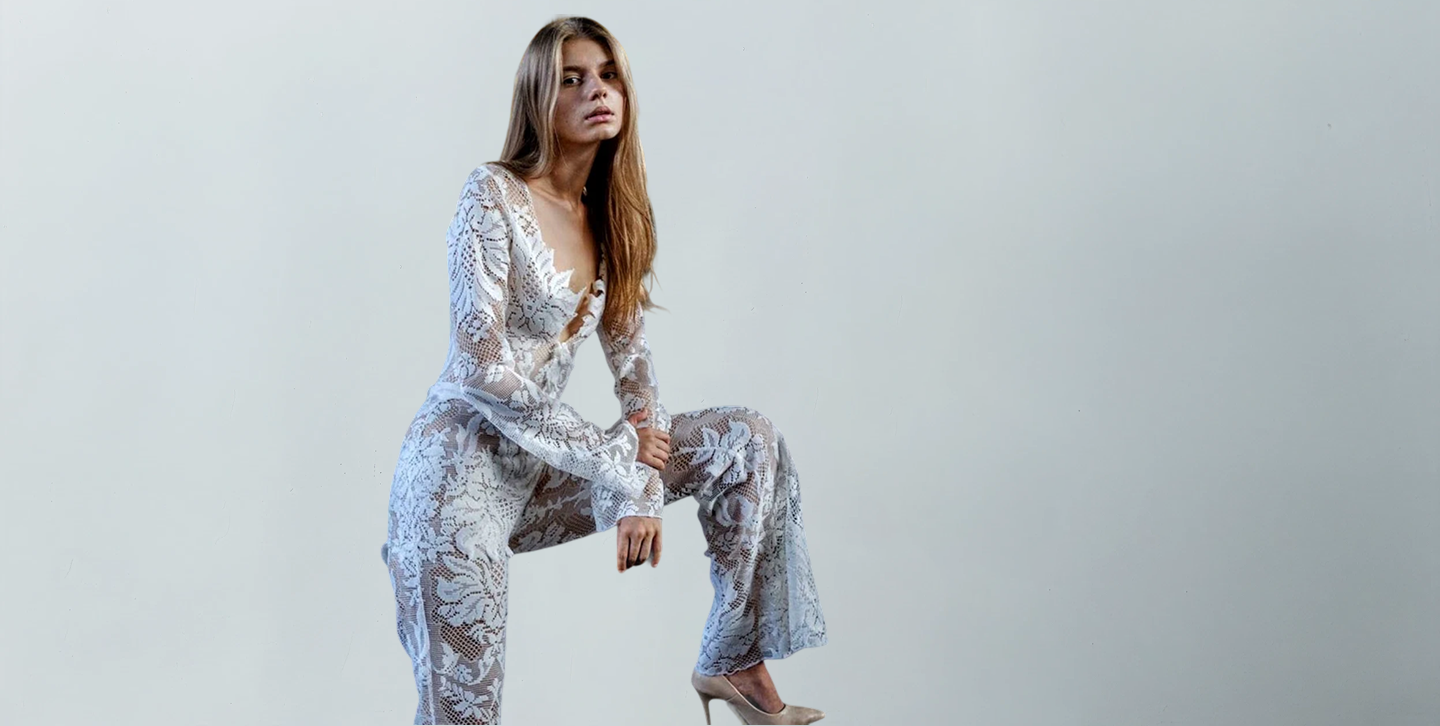 Woman wearing a Handcrafted Bridal Jumpsuit on a light gray background